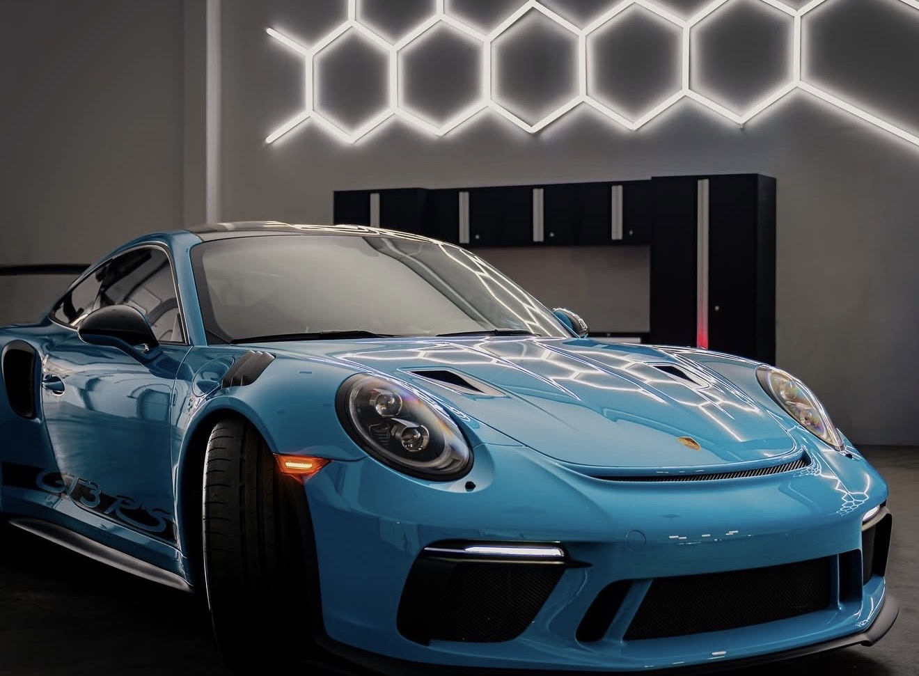 Blue Porsche GT3 RS photographed inside a detailing studio