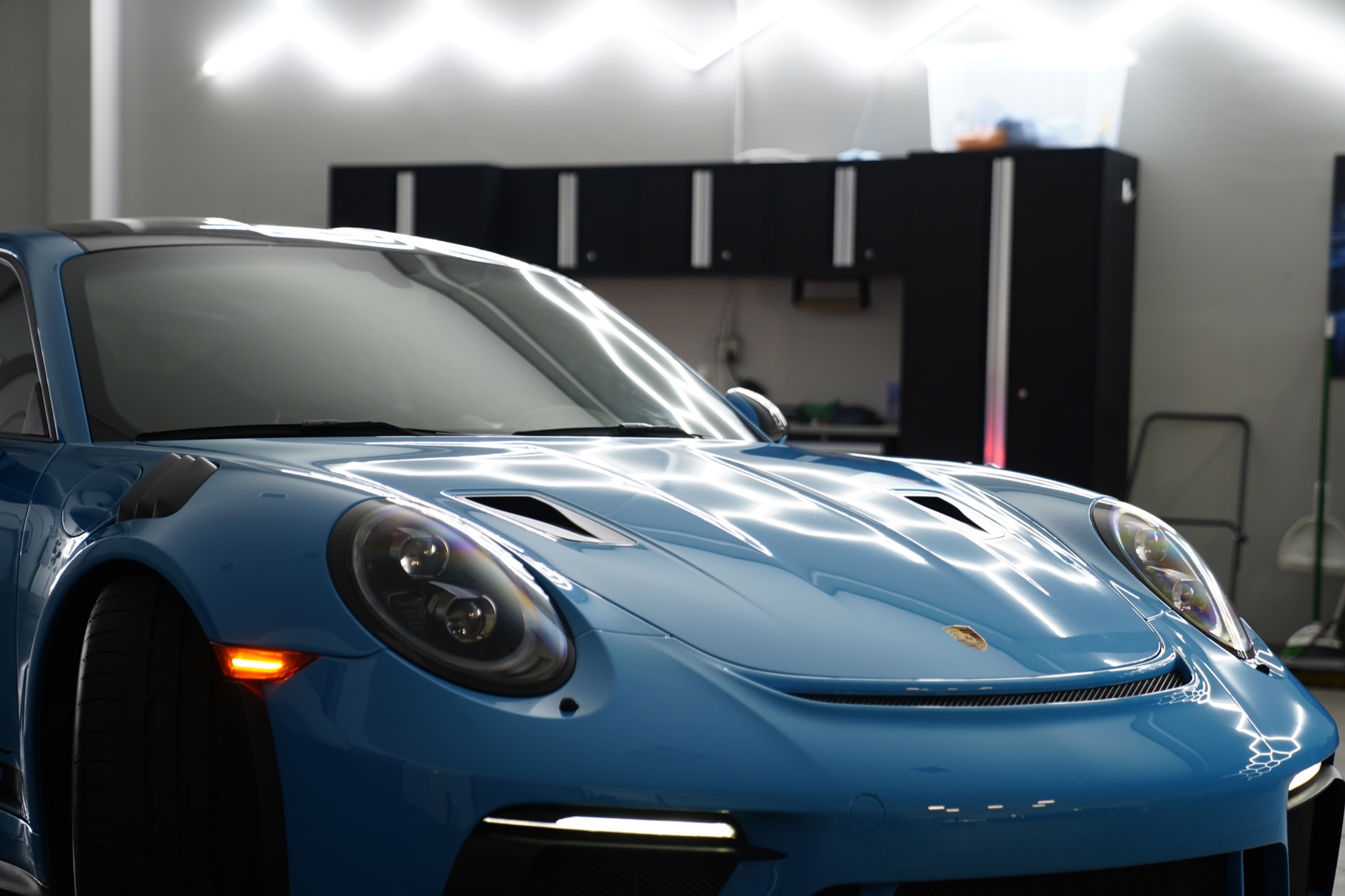 Blue Porsche photographed inside a detailing studio