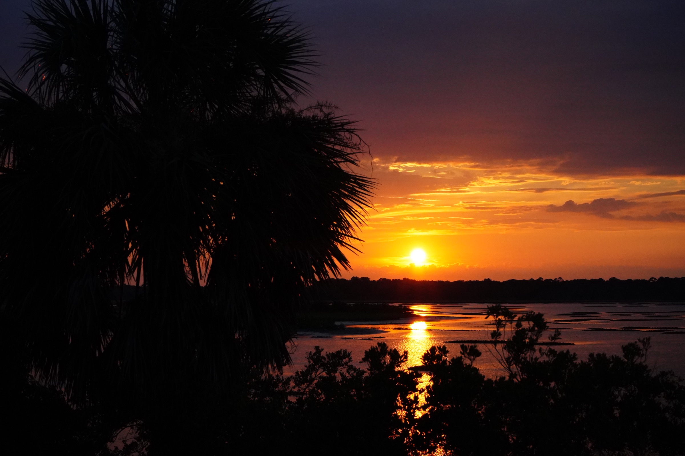 Orange sunset reflected across the water