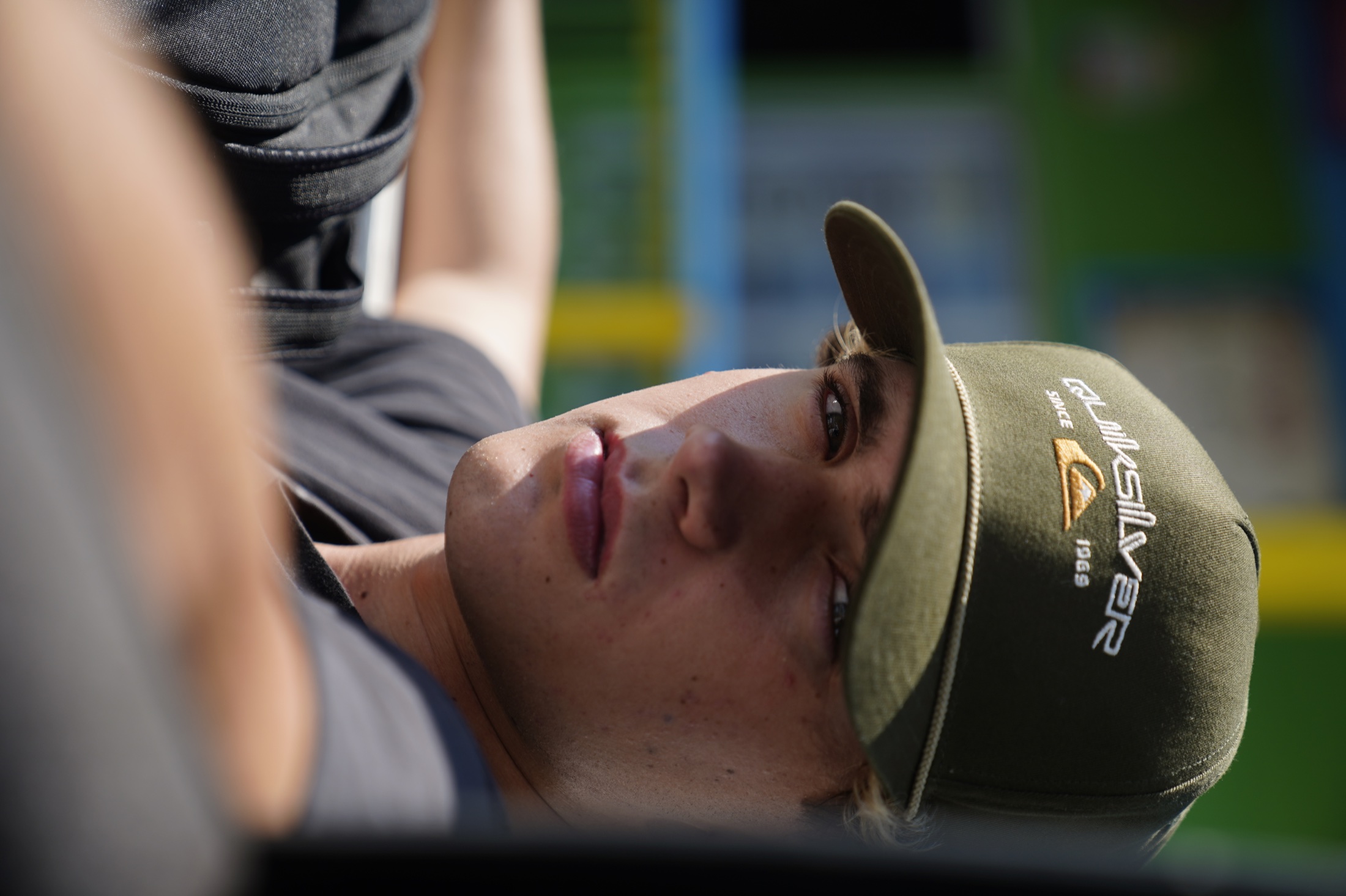 Outdoor portrait of a young man in a cap